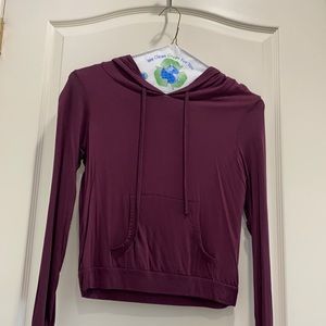 Wine colored top with a hood and pockets.